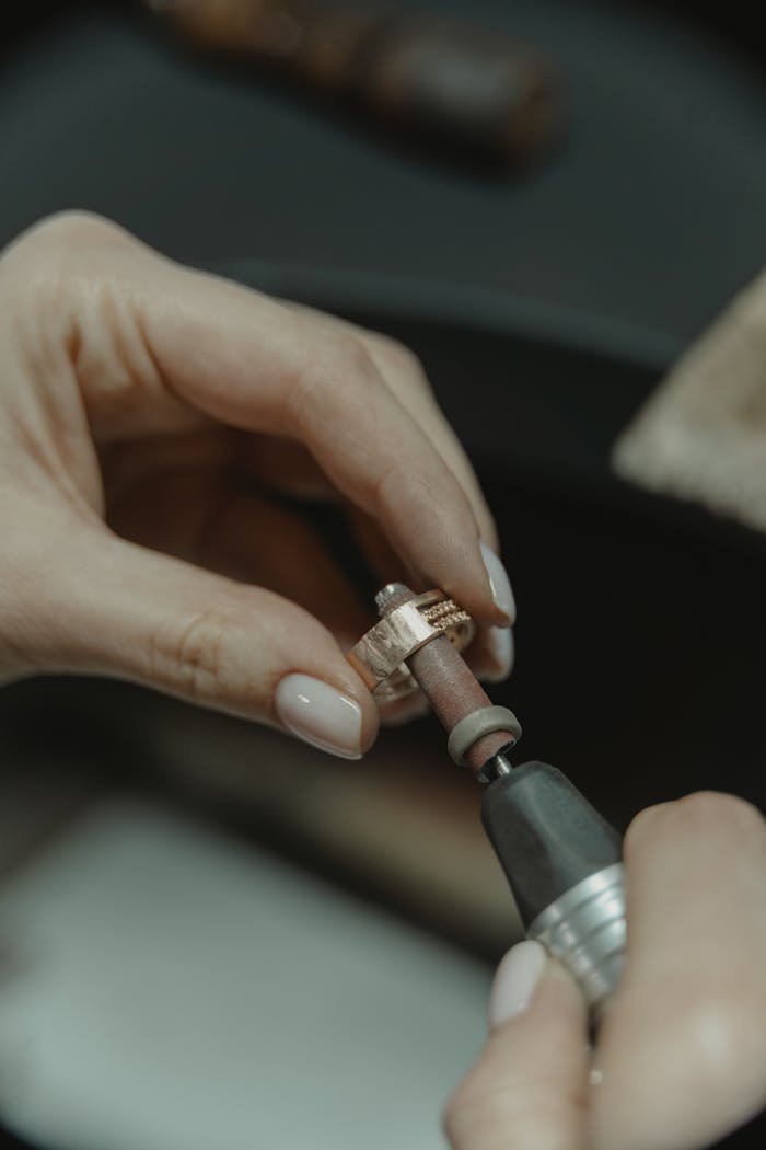 Detailed shot of a skilled jeweler meticulously polishing a ring.